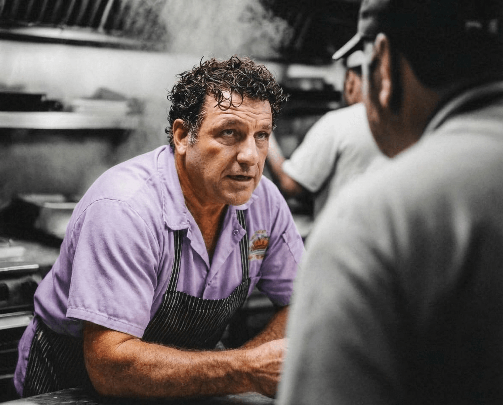 Executive chef plating a dish in a restaurant kitchen